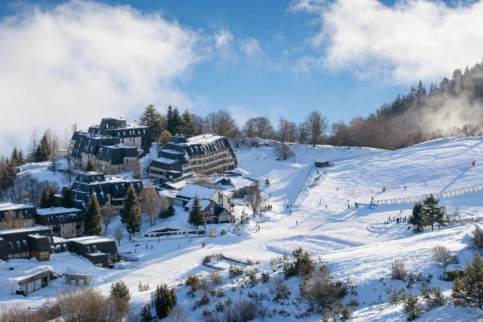 Vue générale de la station de Val Louron avec pistes, hébergements, vallée du Louron et lac de Génos-Loudenvielle dans les Hautes-Pyrénées